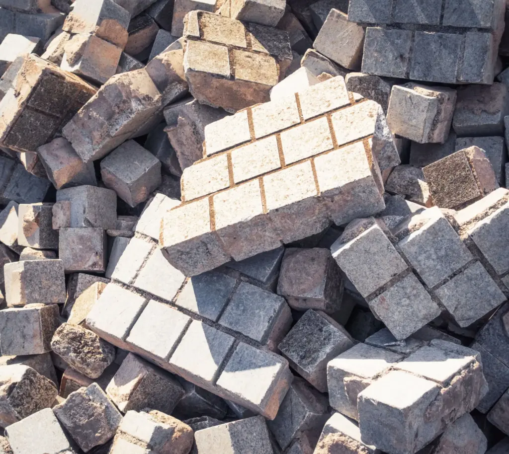 Pile of stone pavers from construction debris ready for removal