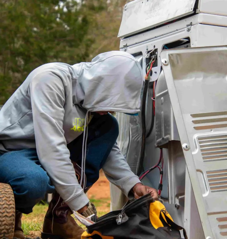 Worker handling tools and debris during junk removal job in Greenville SC